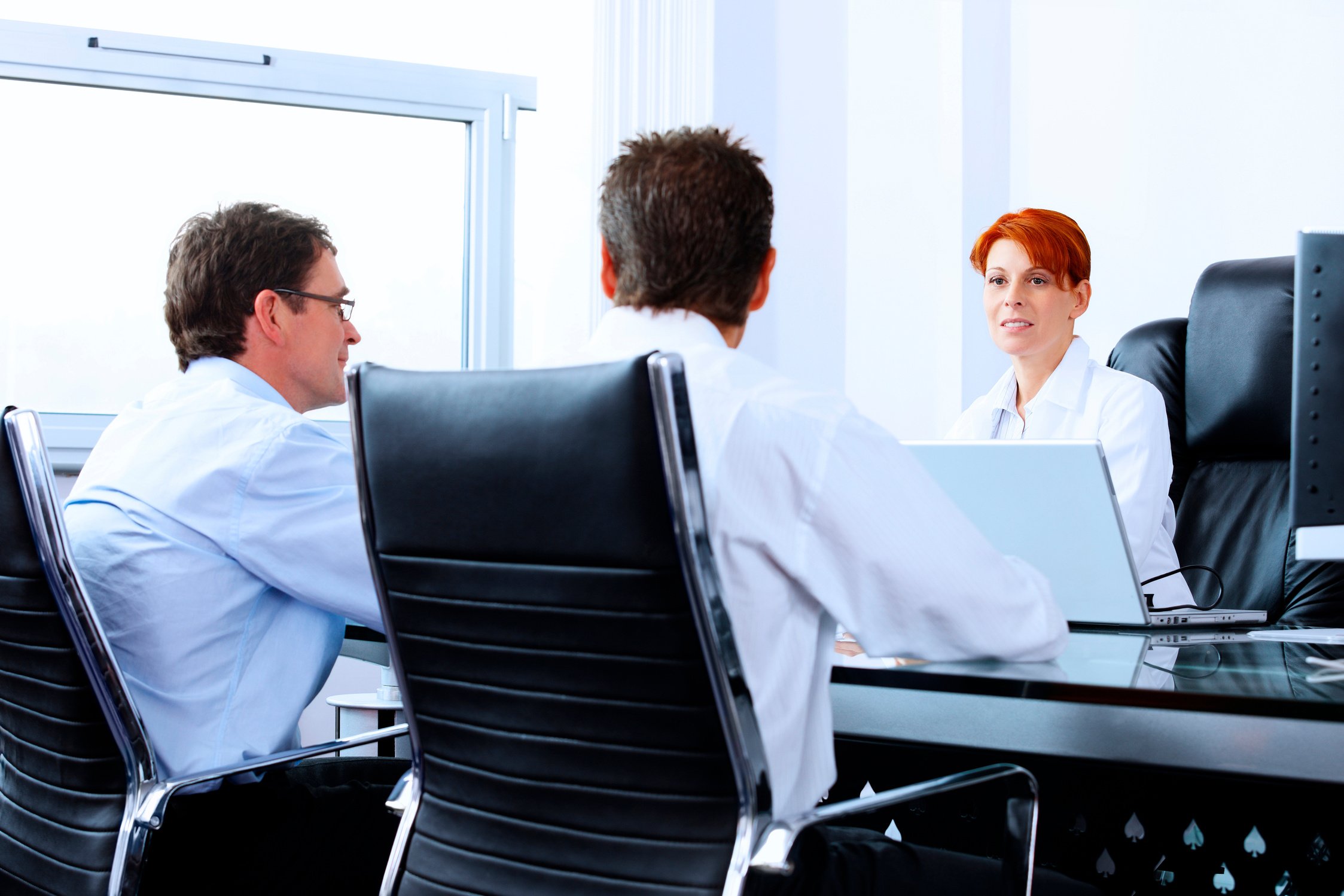 female dotor talking with two male patients